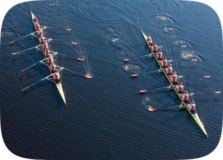 elevated-view-of-two-rowing-eights-in-water-solutions